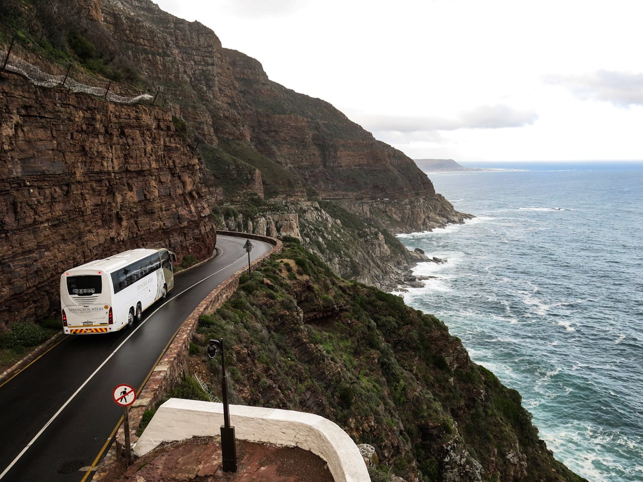 services-04 A scenic road trip along dramatic coastal cliffs in South Africa, ideal for travel and adventure.